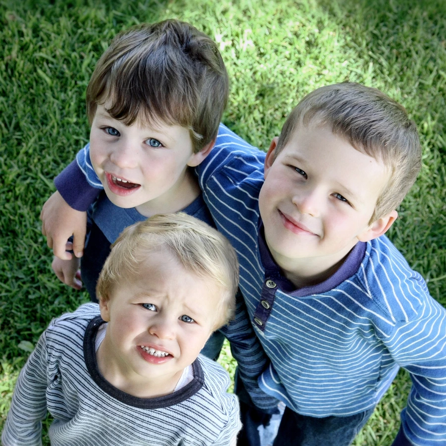 3 kids looking up at camera